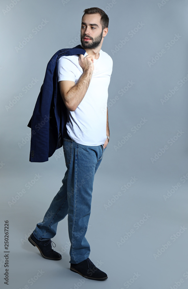 Handsome fashionable man on grey background