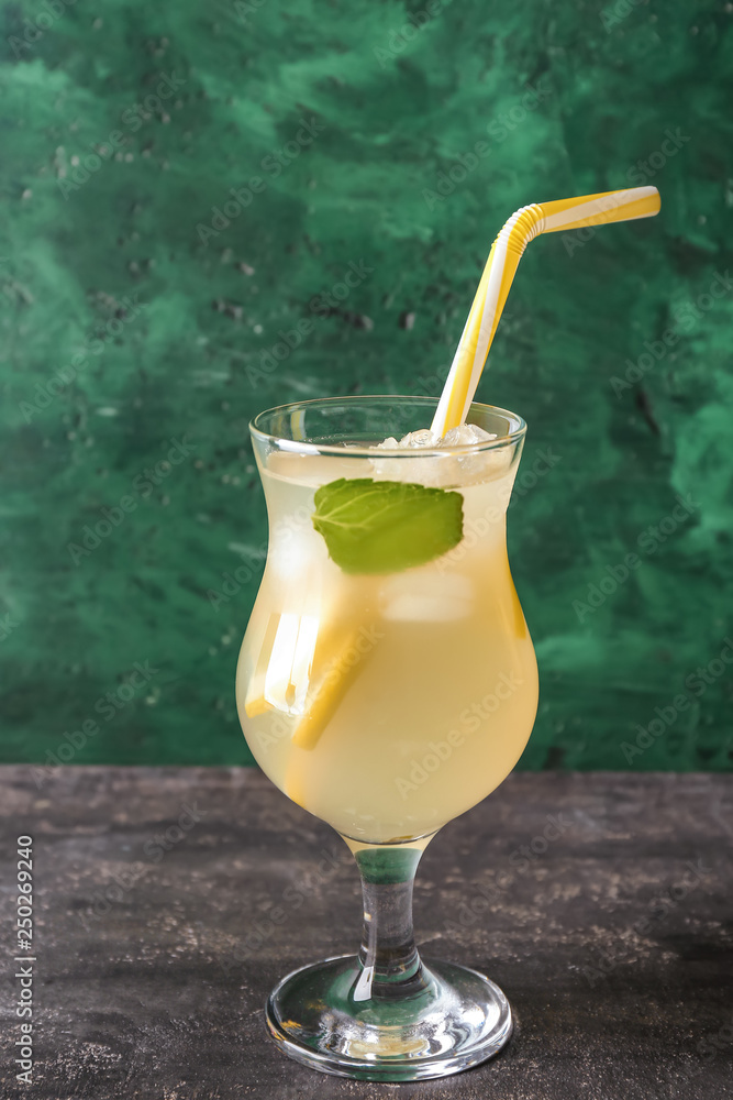 Glass of fresh lemonade on table