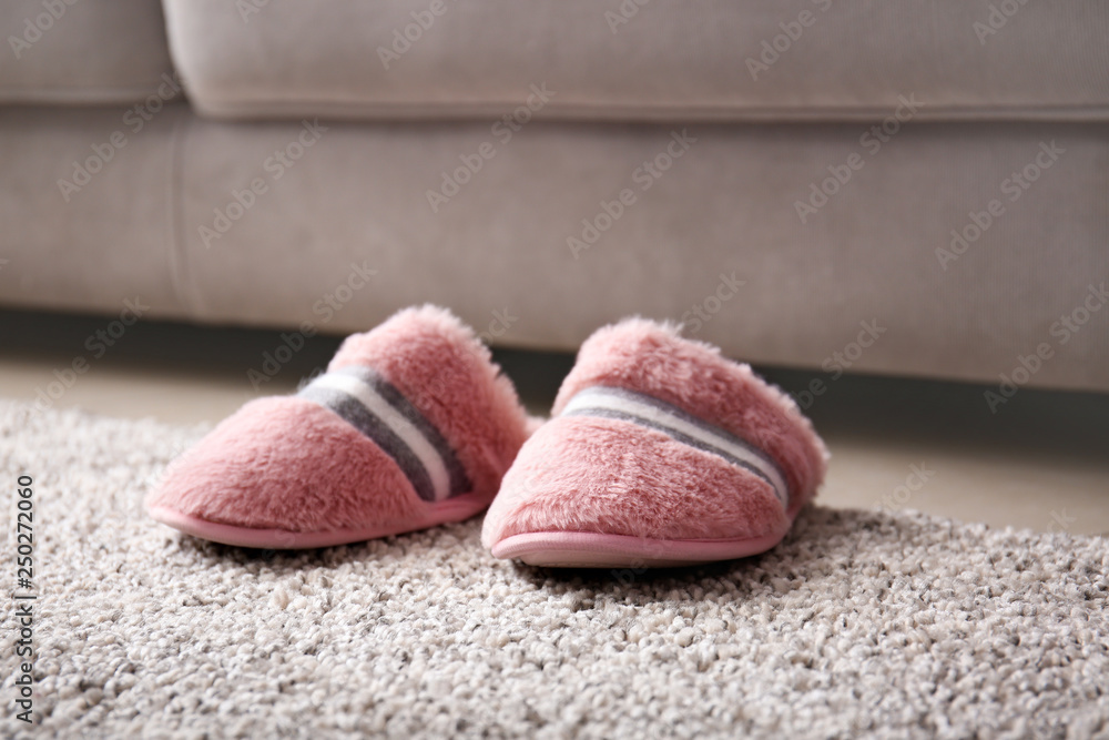 Soft slippers on carpet in room