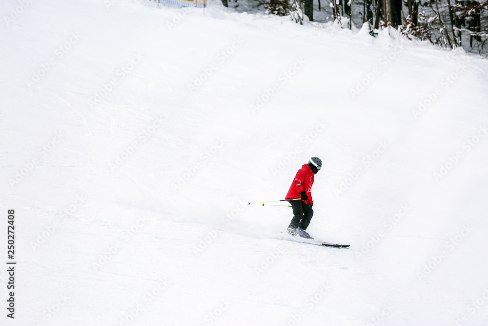 Sporty skier at winter resort