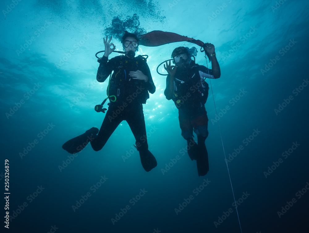 Young woman and man scuba divers exploring