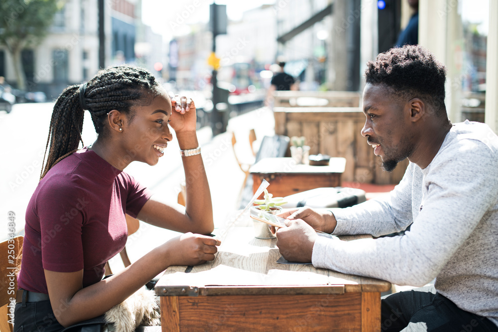 Couple reading the menu at a cafe