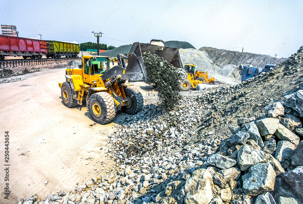 Yellow bulldozer working in quarry