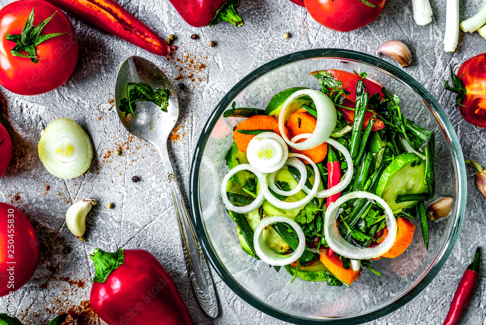 cooking vegetables on the stone background top view