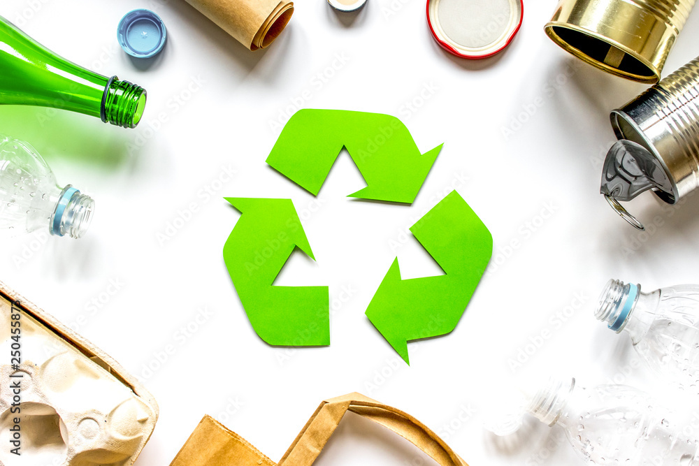 waste recycling symbol with garbage on white background top view