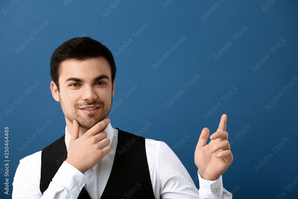 Portrait of handsome young businessman on color background