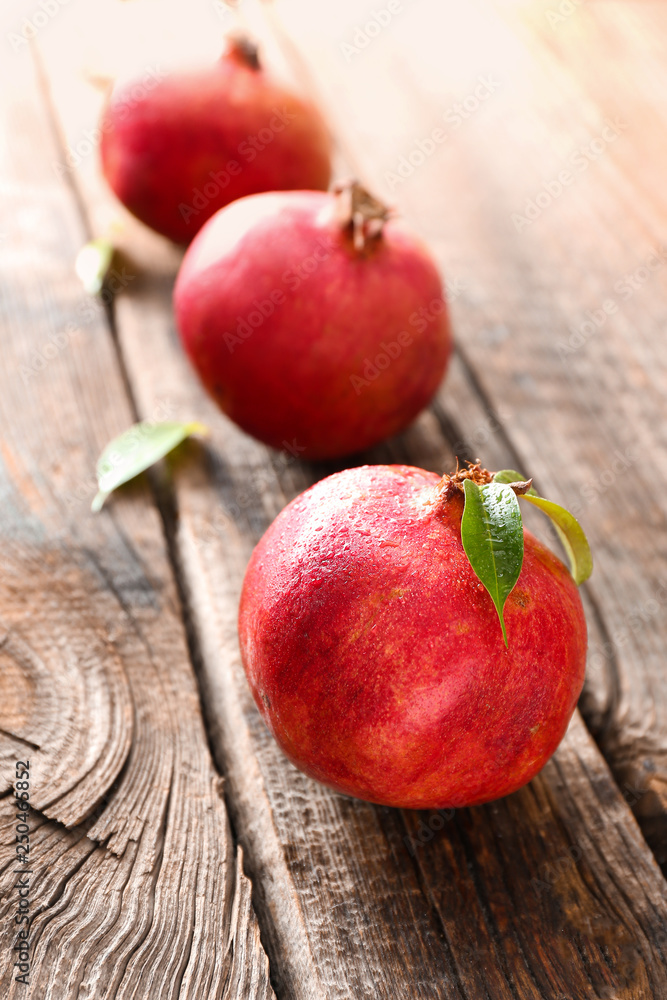 Ripe pomegranates on wooden table