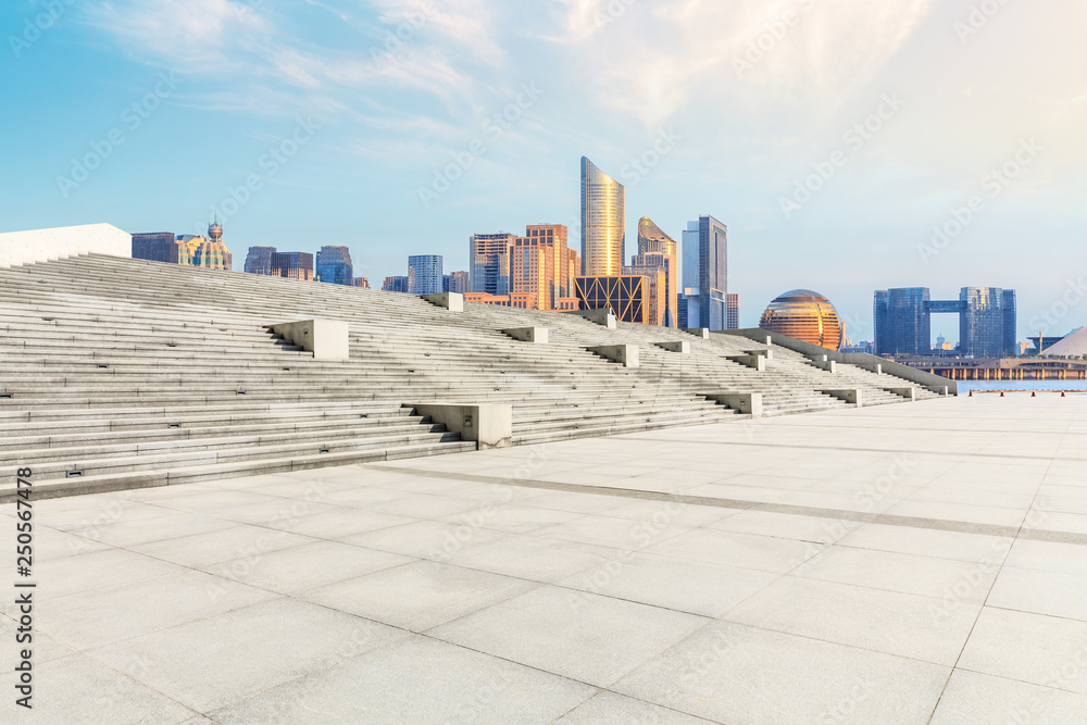 Hangzhou city skyline and empty square floor at sunrise