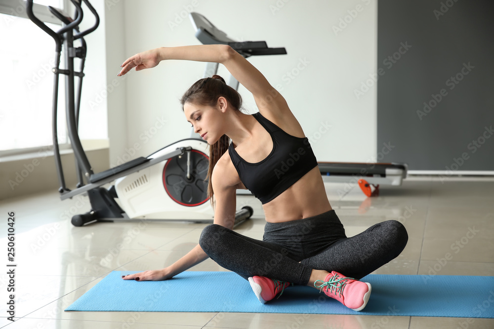 Sporty young woman training in gym