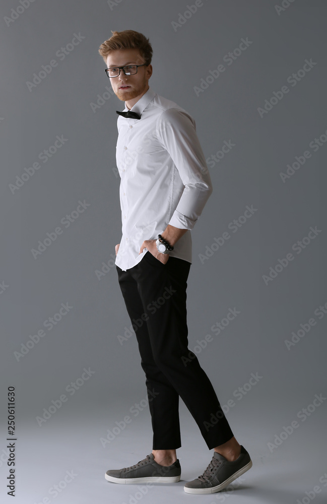 Fashionable young man on grey background