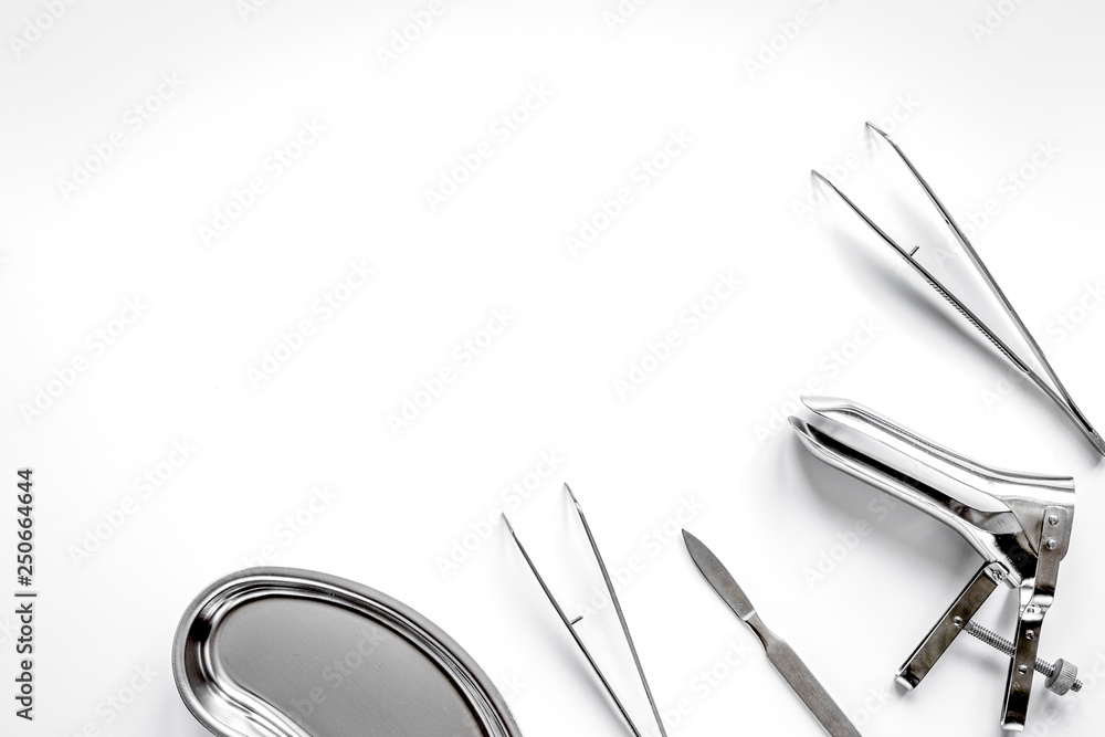 instruments of gynecologist on white background top view