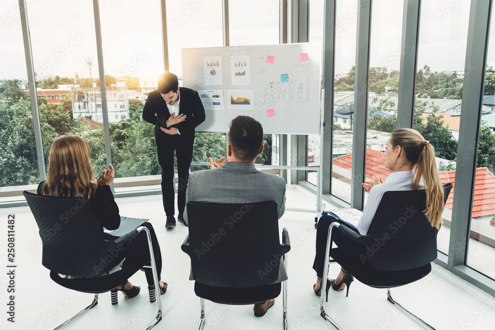 Businesswomen and businessmen in group meeting.