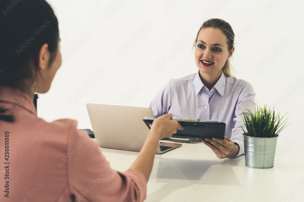 Two young business women meeting for interview.