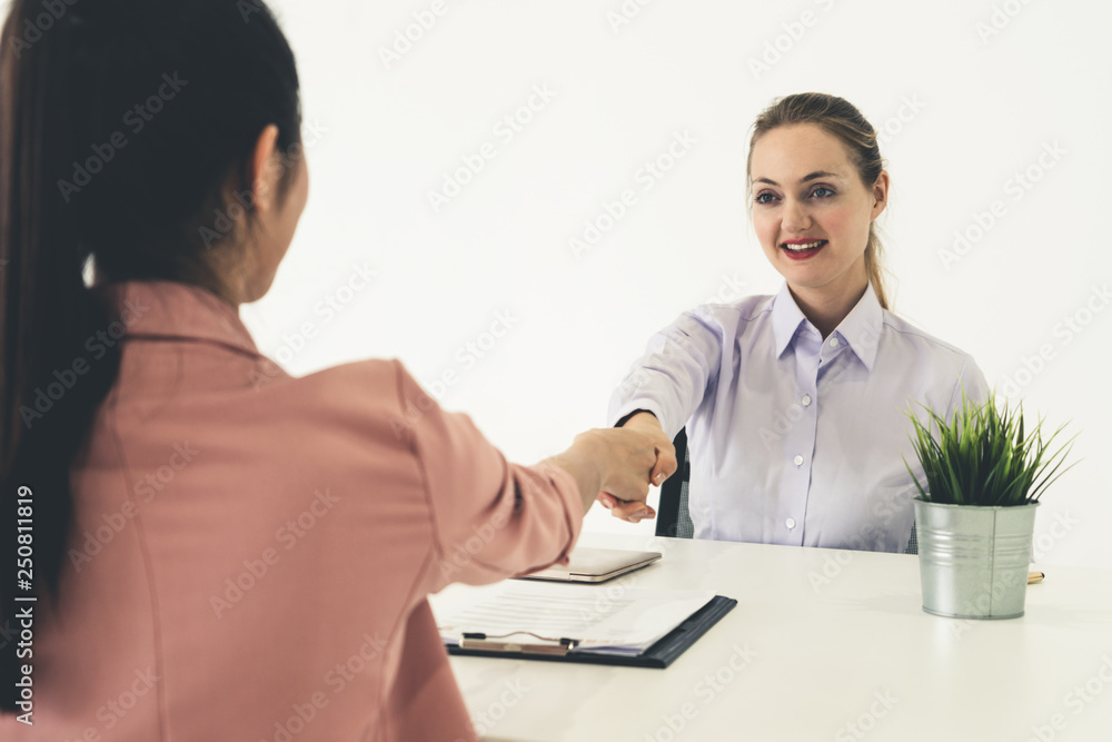 Two young business women meeting for interview.