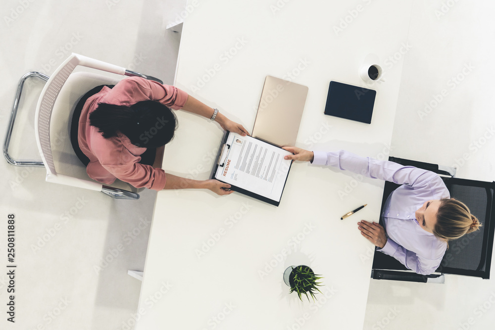 Two young business women meeting for interview.