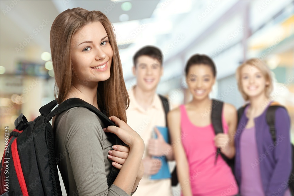 Young female student with people on background