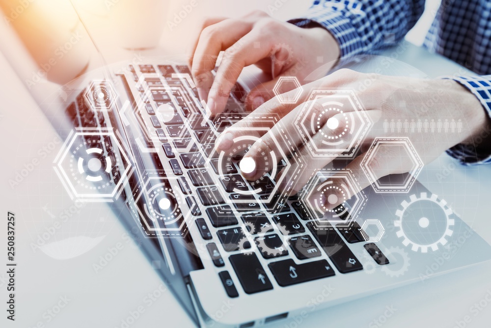 Hands typing on keyboard of modern laptop