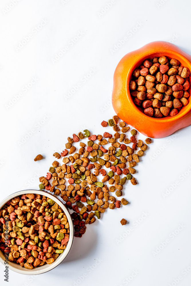 dry pet food in bowl on white background top view