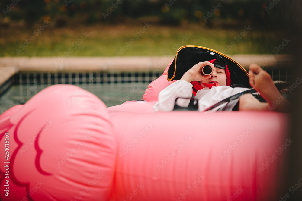 Boy playing pirate in pool