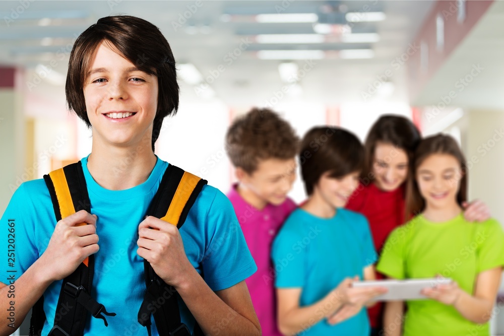 School boy with books and backpack