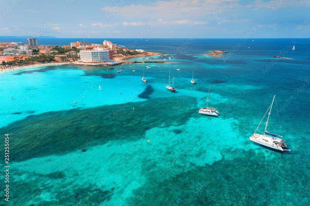 Aerial view of boats and luxury yachts in the clear sea at sunset in summer in Mallorca, Spain. Colo