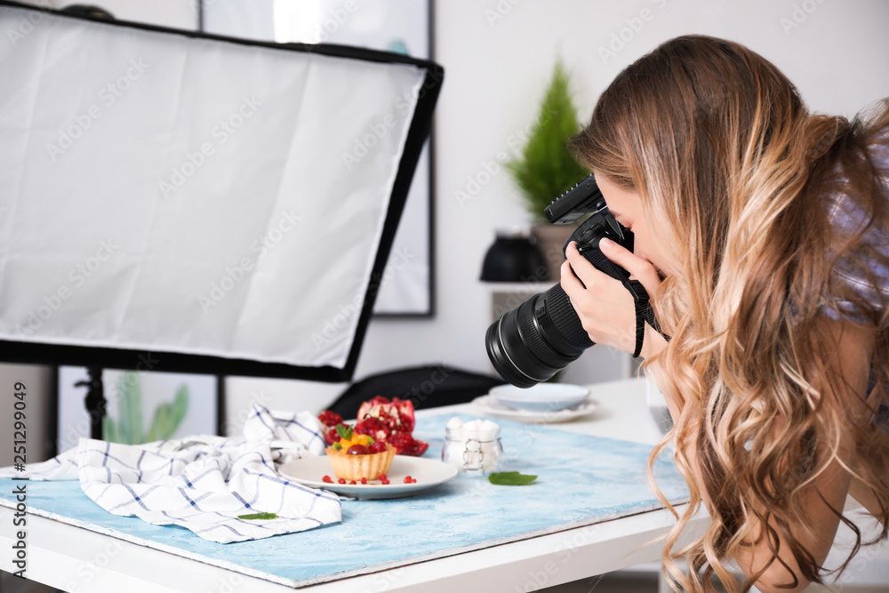 Female food photographer working in home studio