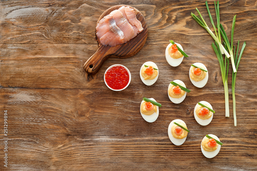 Tasty deviled eggs on wooden table