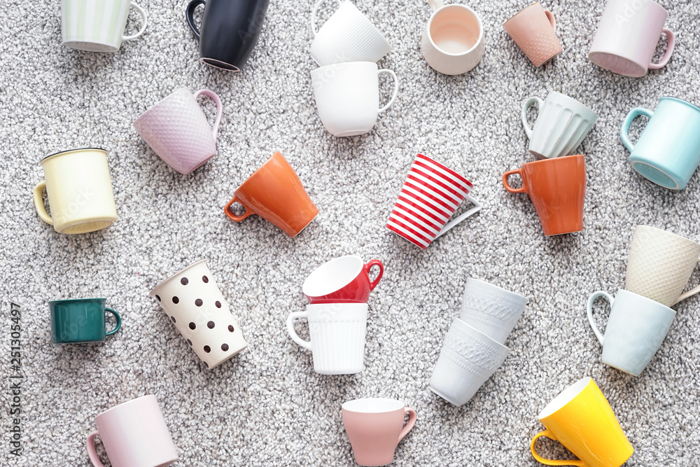 Different tea cups on soft carpet