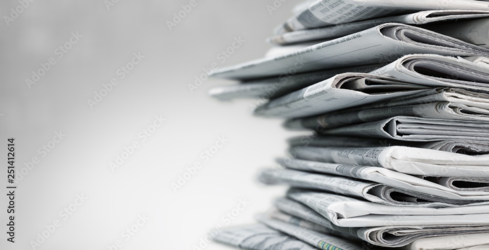 Pile of newspapers on white background