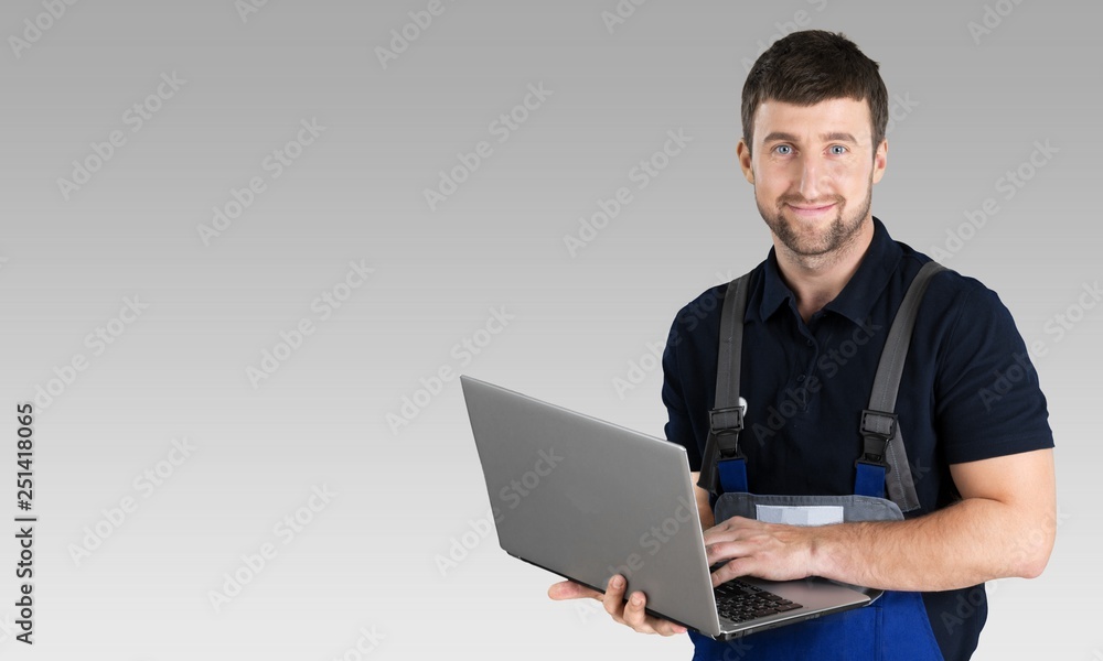 Portrait of cheerful Handsome  mechanic  on background