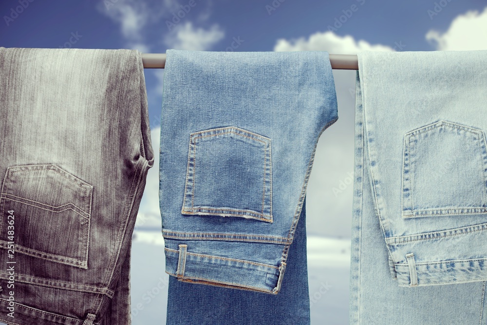 Three pair of different jeans hanging on