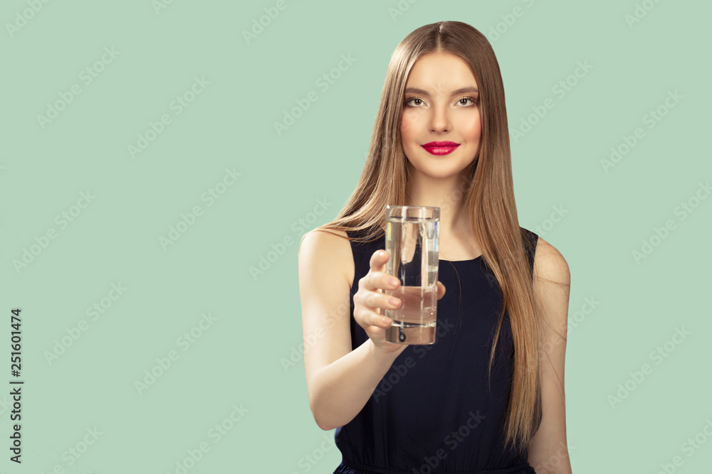 woman holds a glass in her hand. Turquoise background. Copycpase