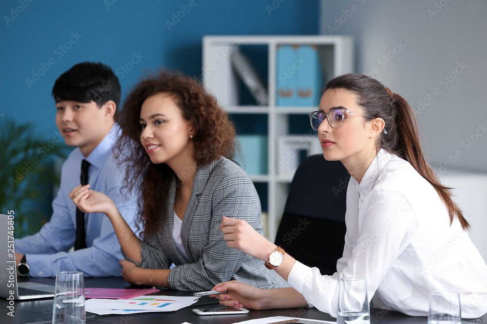 Young people having business meeting in office