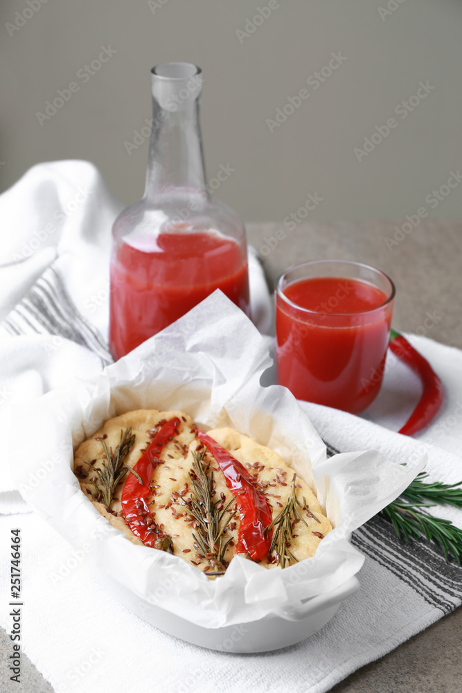 Baking dish with tasty Italian focaccia on grey table