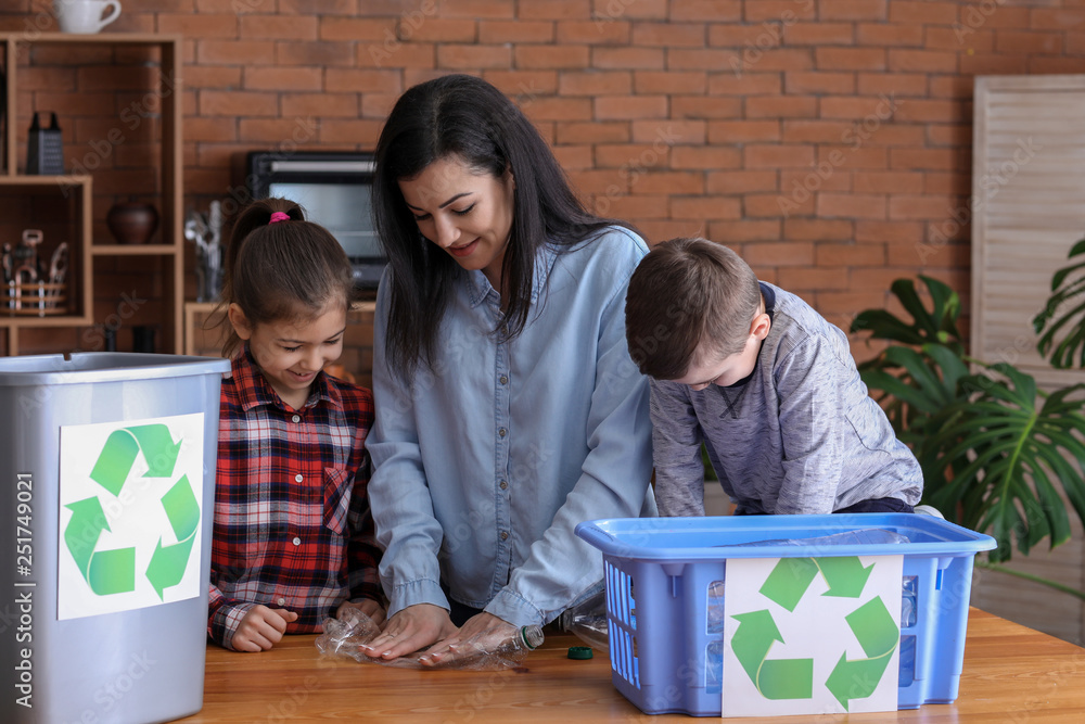 Family sorting garbage at home. Concept of recycling