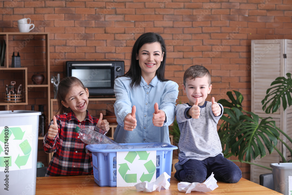 Family sorting garbage at home. Concept of recycling