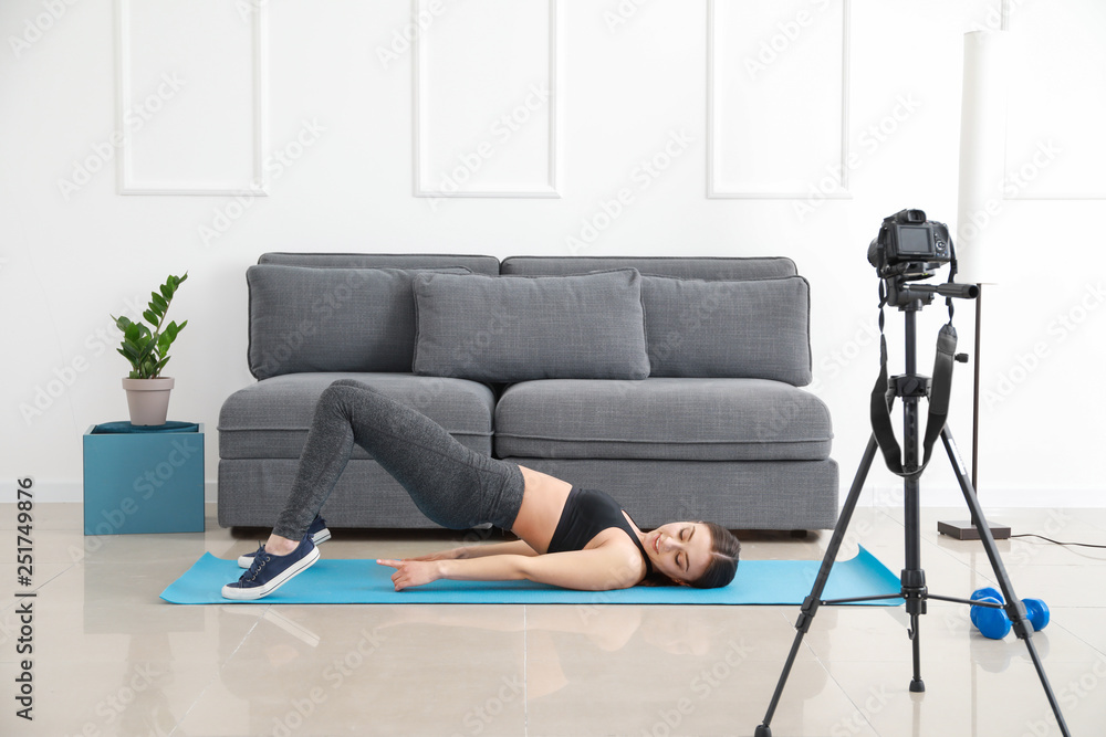 Female blogger recording sports video indoors