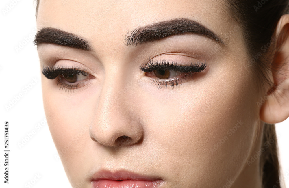 Young woman with beautiful eyebrows on white background, closeup