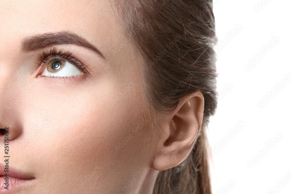 Young woman with beautiful eyebrows on white background, closeup