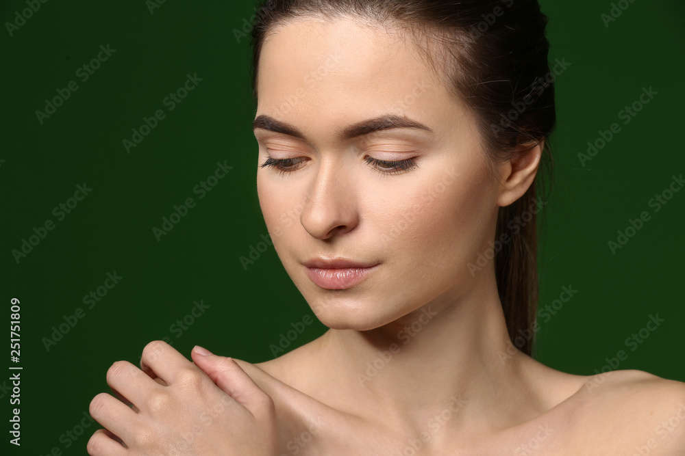 Young woman with beautiful eyebrows on color background