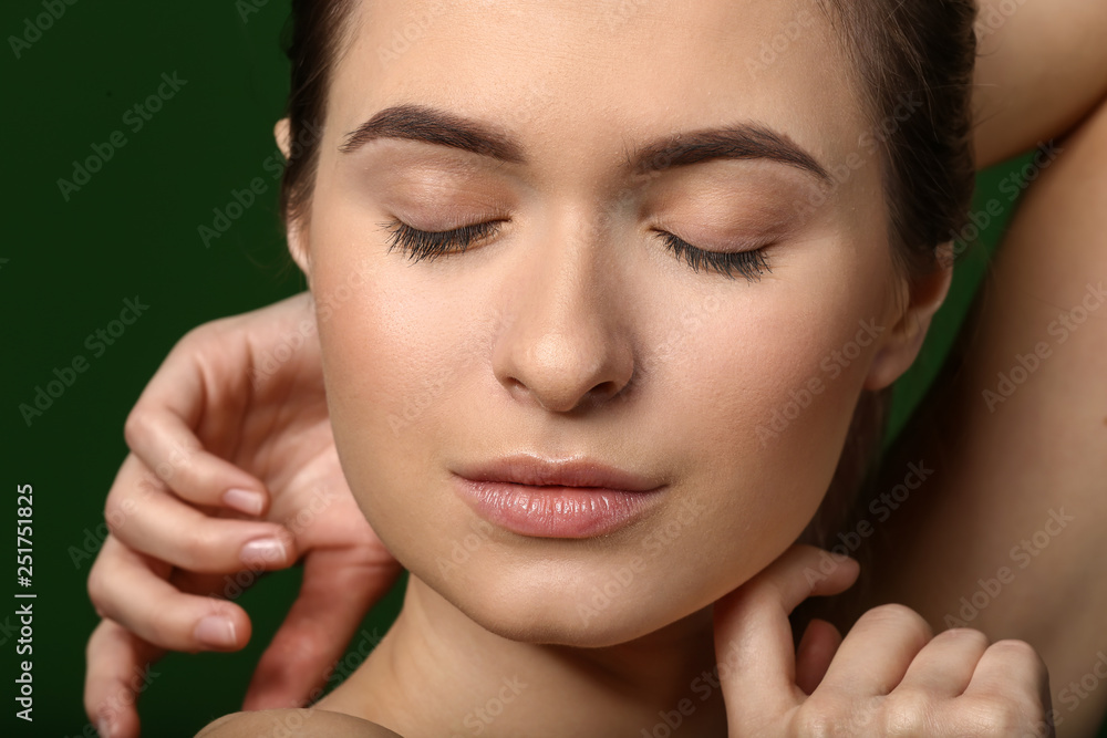 Young woman with beautiful eyebrows on color background, closeup