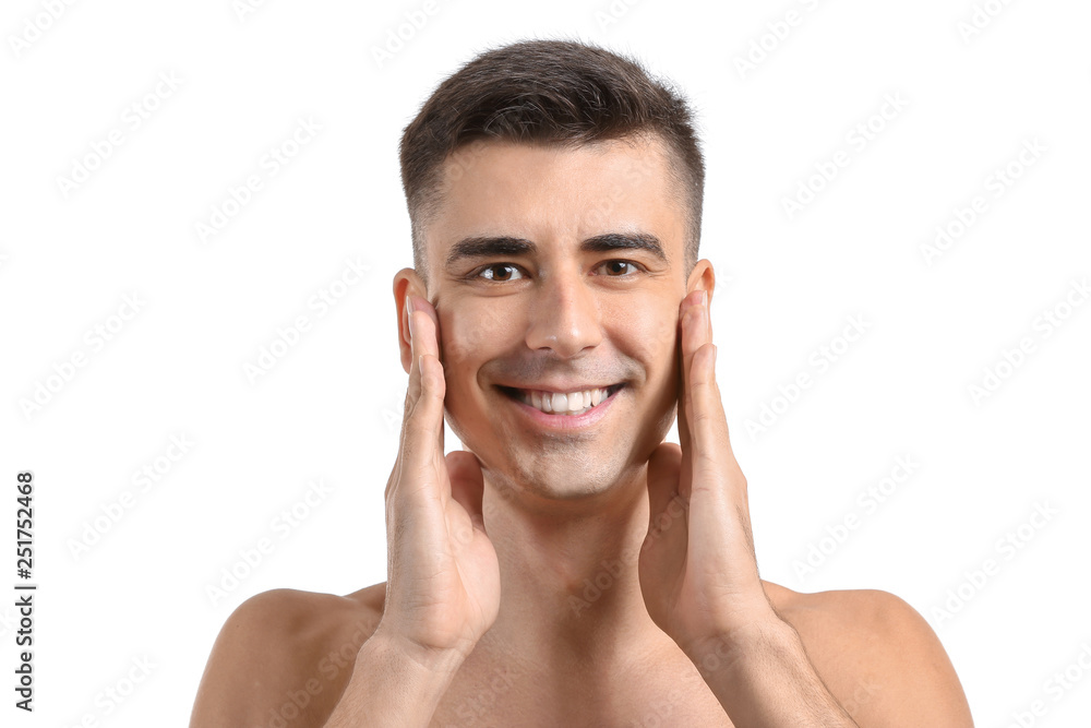 Man giving himself face massage on white background