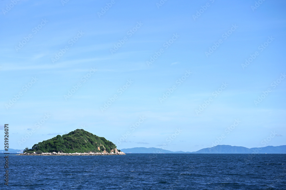 Small tropical island in the sea at Pattaya, Thailand. Seen in nice weather day with beautiful blue 