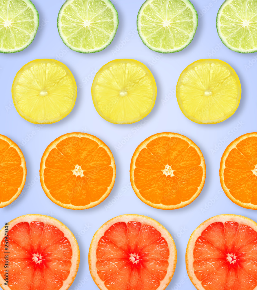 Slices of fresh citrus fruits on color background