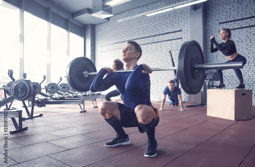 Sporty man training in weight room