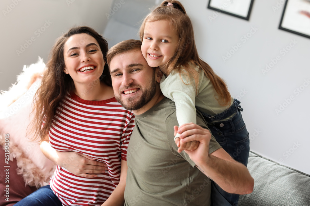 Portrait of happy family expecting baby at home