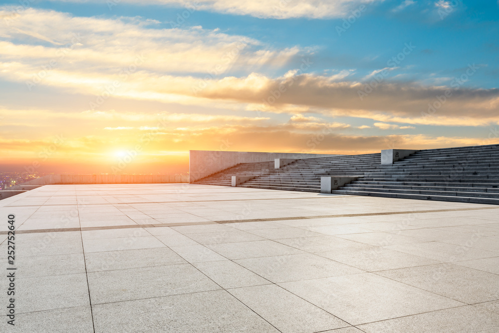 Empty square floor and modern city skyline with beautiful colorful clouds at sunset