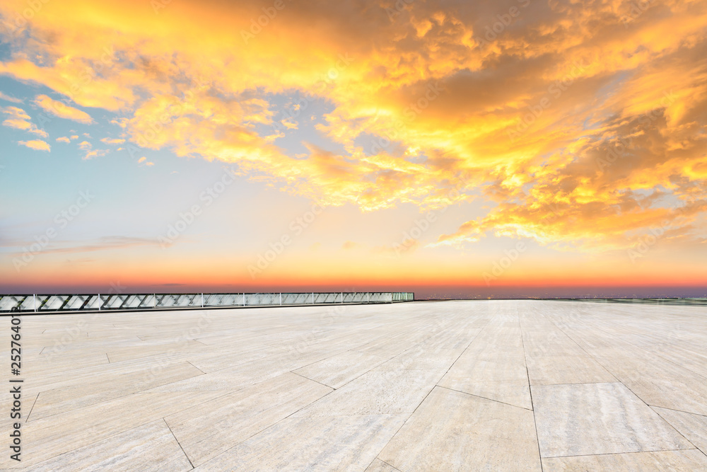 Empty square floor and modern city skyline with beautiful colorful clouds at sunset