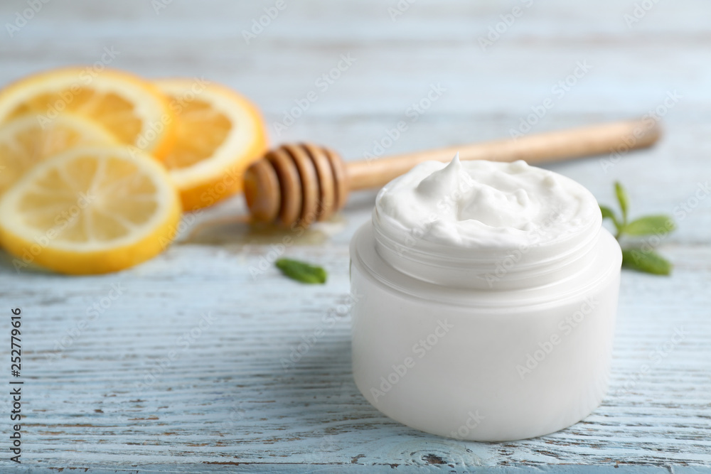 Jar of natural cream on wooden table