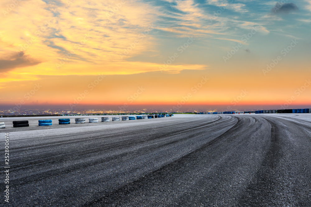 Empty asphalt square ground and city skyline with beautiful clouds at sunset